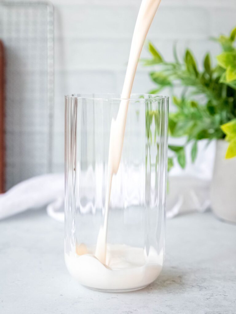 action shot of pouring milk into a glass.