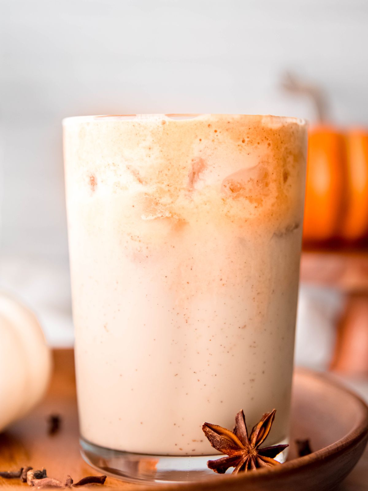 closeup shot of an iced chai latted topped with pumpkin cream cold foam.
