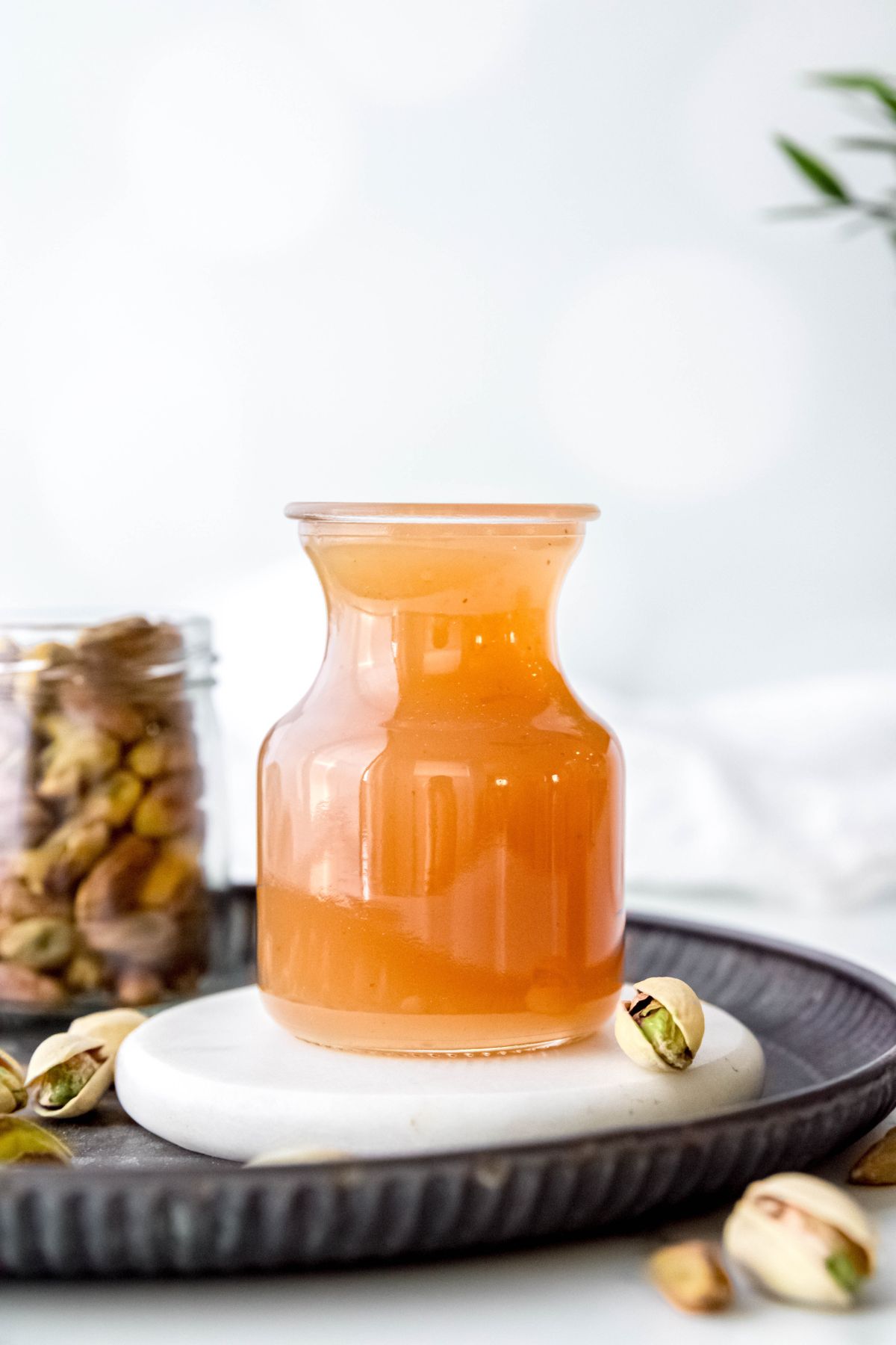 small carafe filled with golden-hued pistachio syrup.