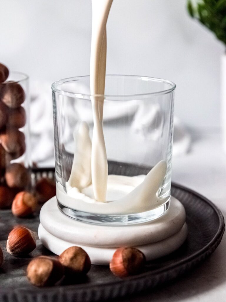 process shot - adding milk and cream to a glass.