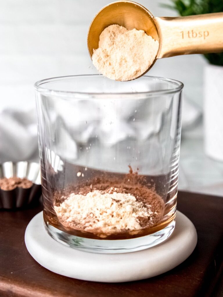 The ingredients needed for a chocolate cold foam being poured into a container.