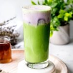 square hero shot of a copycat iced lavender cream oat milk matcha from Starbucks showing the bright green matcha on the bottom and pale purple cold foam on top.