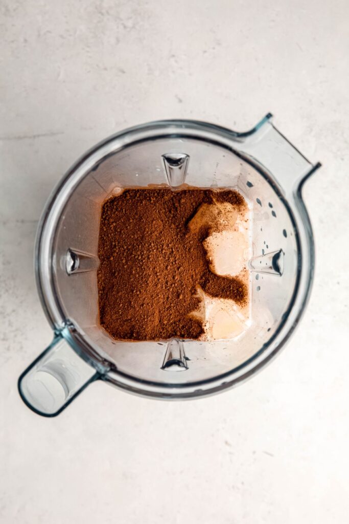 The milk, ice, and hot chocolate mix in a blender.