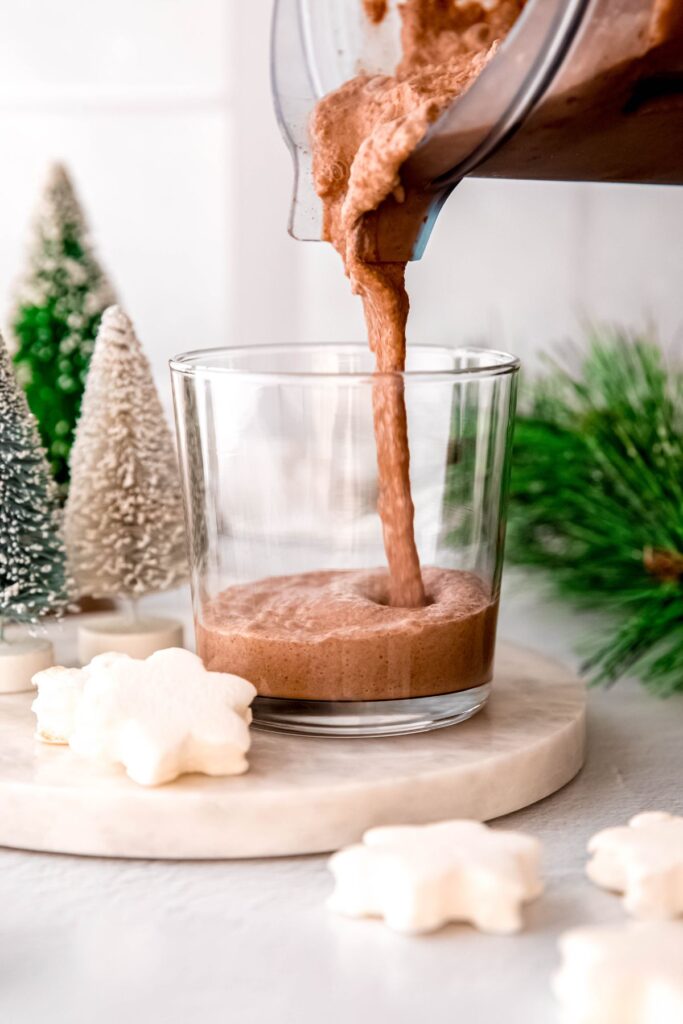 Pouring the frozen hot chocolate into a small glass.