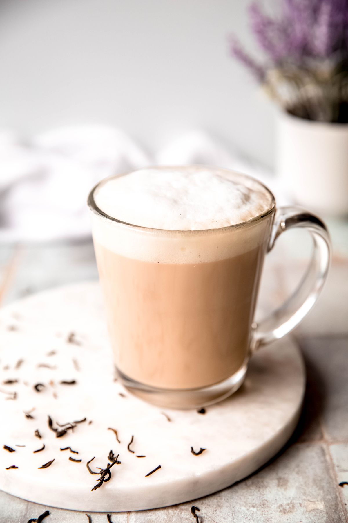 hero shot of an earl grey tea latte topped with frothy milk foam. 