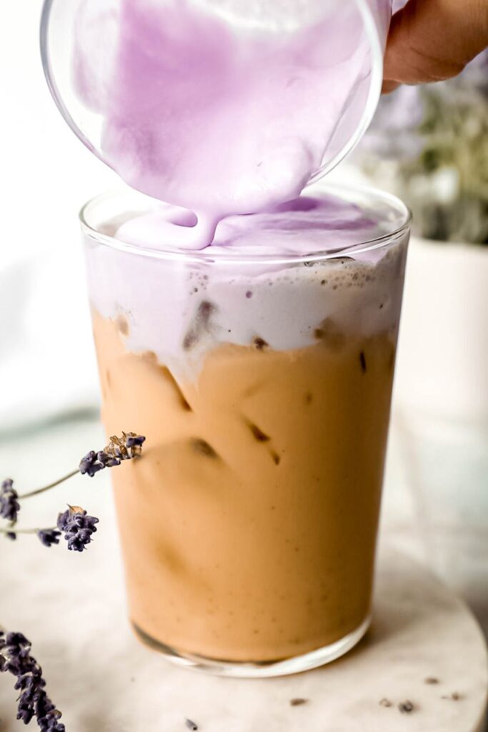 Topping the iced chai with the lavender cream cold foam. 