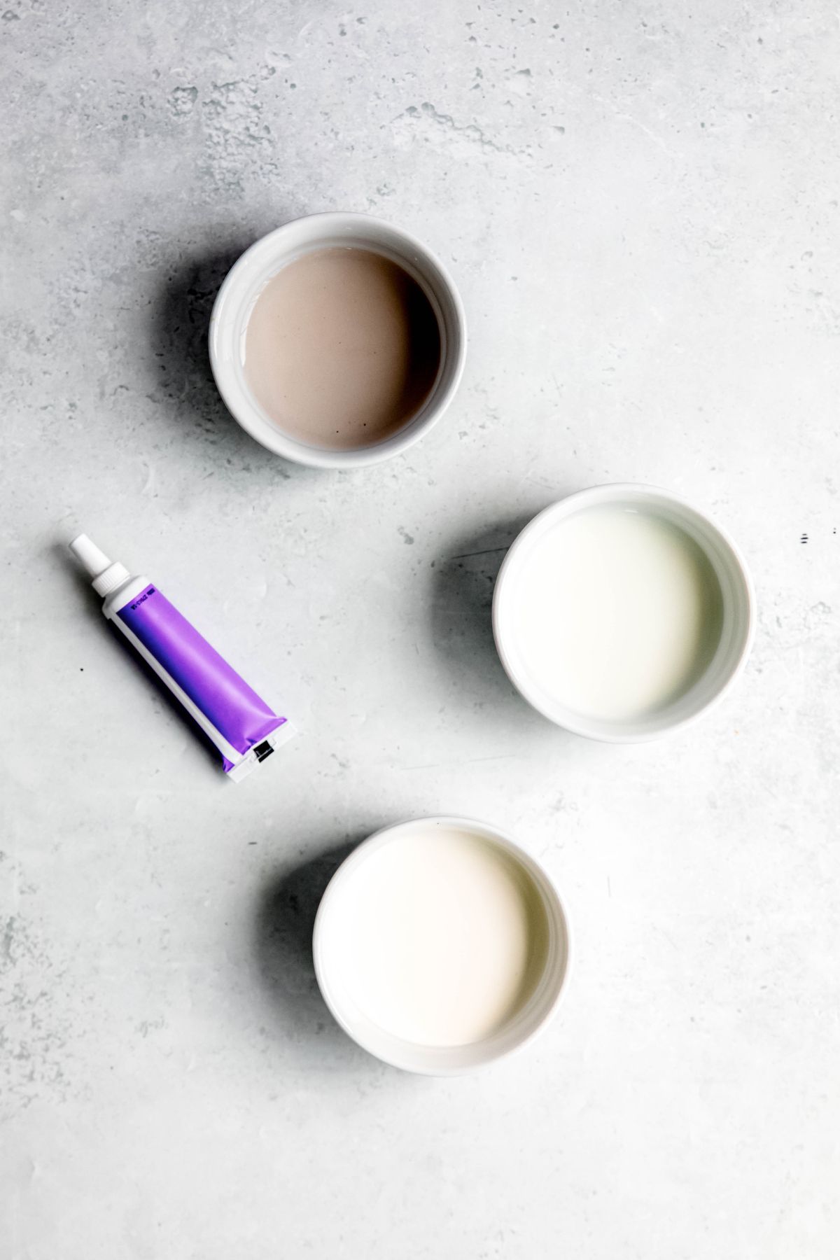 ingredients needed to make homemade lavender cold foam recipe measured out in white bowls on a white table.