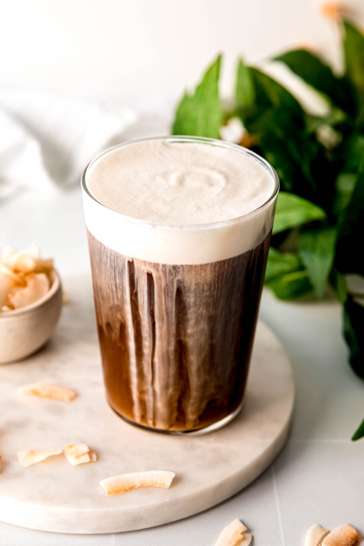 A tall glass of my coconut cream cold brew recipe sitting on the counter before enjoying. 