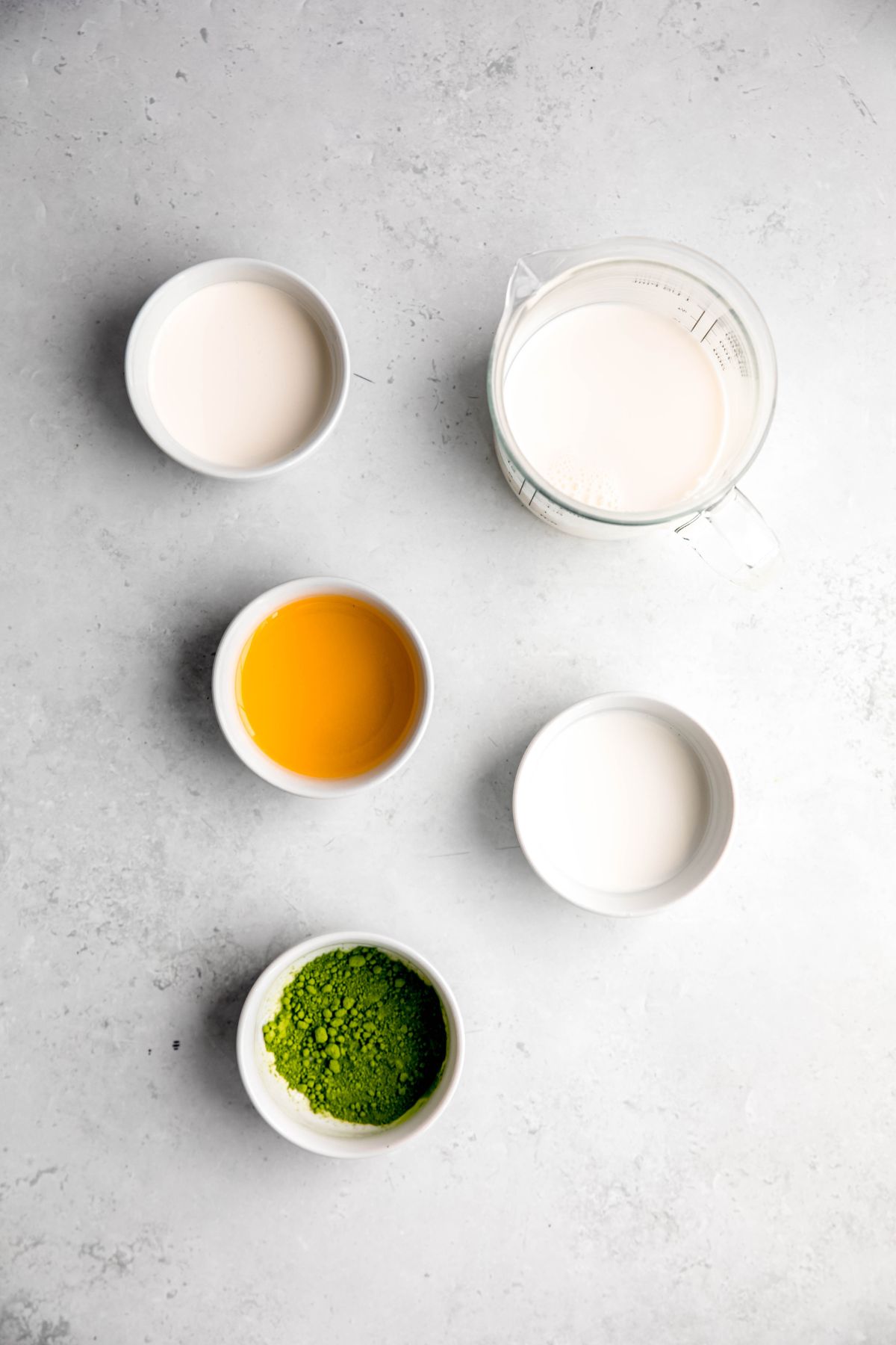 ingredients needed to make Starbucks iced mango cream matcha recipe at home measured out on a white table. 