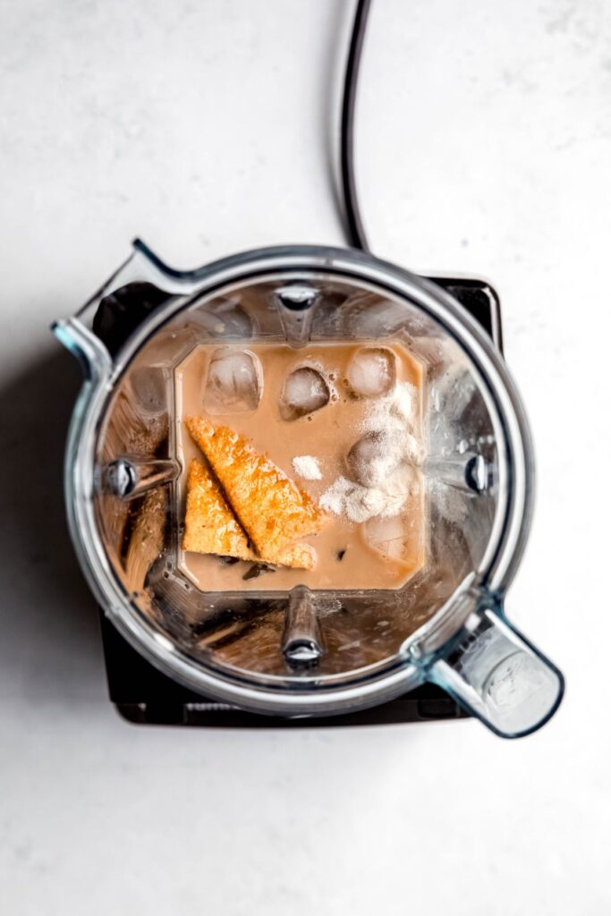graham cracker frappe ingredients added to a blender.