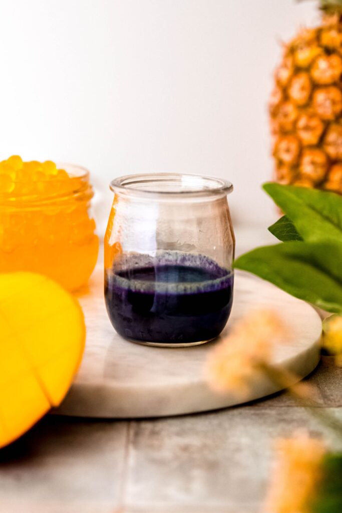 butterfly pea flower layer mixed together in a small glass jar.